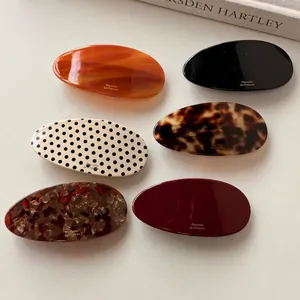 Set of six oval acetate barrettes with marble, polka dot and tortoiseshell patterns
