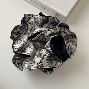Detail of French vintage scrunchie with black and white toile de jouy forest pattern