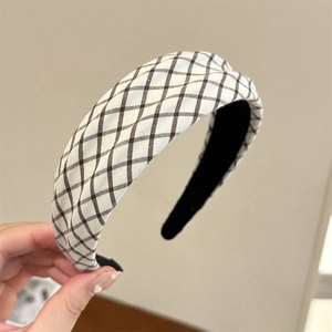 Close-up of beige and brown plaid headband with soft fabric texture and anti-slip lining