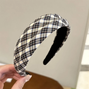 Close-up of vintage blue and white plaid fabric texture on a wide padded headband