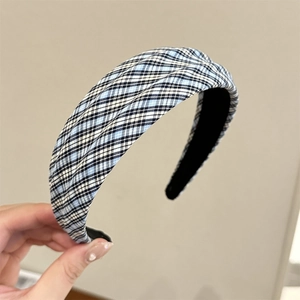 Detailed view of the blue and black plaid fabric texture on a wide padded headband