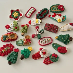 Detailed close-up of handmade crochet Christmas hair clips with festive knitting patterns