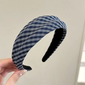 Detail of blue plaid fabric headband featuring a non-slip black frosted inner lining