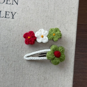 Detailed macro view of handmade crochet flower hair clips with soft knitted wool texture