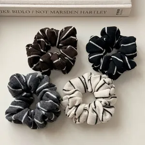 Set of four striped knitted scrunchies in brown black grey and cream colors
