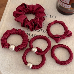 Deep burgundy satin hair scrunchies set with pearl and bow accents for women