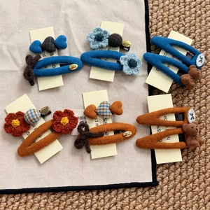 Handmade wool flower and bear hair clips set in navy blue and orange for women