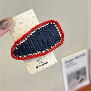 Detailed macro view of the tri-color knitted wool hair clip in red white and blue finish