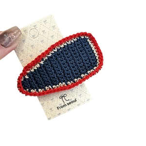 Handmade crochet BB clip with blue and red wool knit pattern on premium card