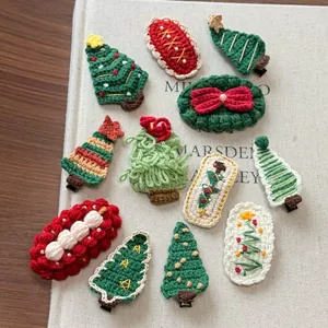 Detail of handmade crochet Christmas hair clips with festive trees and bow designs