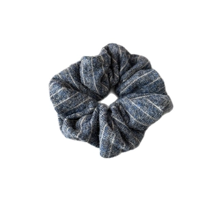 Blue and white striped knit scrunchie with soft ribbed texture and elastic design
