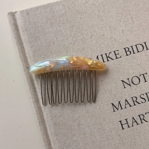 Close-up of tortoise shell pattern acetate comb with FRANCE Handmade engraving