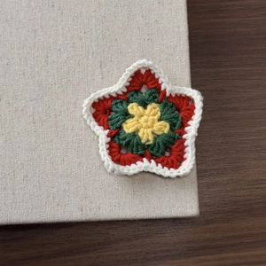Detailed macro of a handmade star crochet hairpin with multi-color knit layers