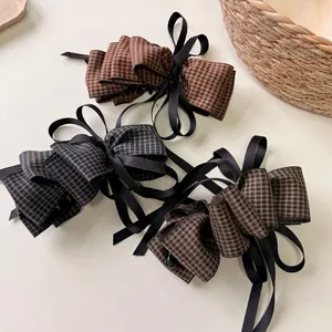 Elegant houndstooth bow hair clips with long black satin ribbons in a set of three