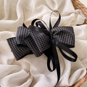 Elegant retro black ribbon bow hair clip in layered plaid design on cream linen fabric
