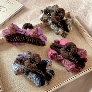 Set of four plush knitted bow hair claws in purple, grey, pink, and green colors