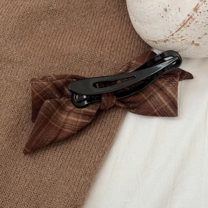 Vintage brown plaid bow hair clip on a cozy knit sweater, retro autumn aesthetic accessory