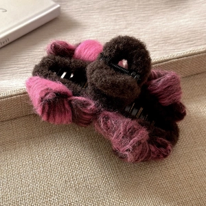 Pink and brown plush bow hair claw clip for elegant updo hairstyles in winter