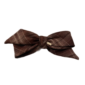 Retro plaid bow hair clip in brown wool fabric with a small golden metal logo plate