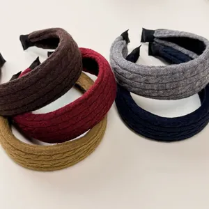 Detailed macro of cable knit twisted headband set in five vibrant assorted colors