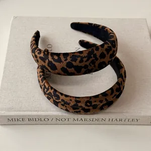 Leopard print headband set for women with retro chic velvet texture on a book background