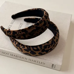 Vintage leopard print wide headband set for women on linen book display