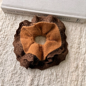 Detailed macro view of brown lace and knit fabric texture of the hair scrunchie