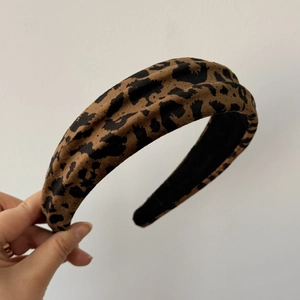 Close-up of leopard print headband with textured fabric and wide design for volume