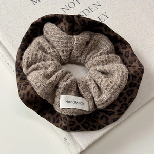 Detail showing knit wool and leopard print fabric textures with HandMade label