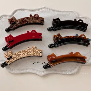 Chic acetate cat-shaped banana clips set with bow detail and rhinestone eyes