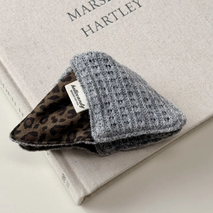 Detail of waffle knit fabric and leopard print lining on a stylish scrunchie accessory