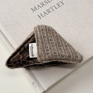 Close-up of vintage knit scrunchie with leopard print lining and brand label detail