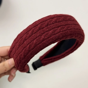 Close-up of deep burgundy cable-knit headband with non-slip inner base and soft ends