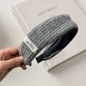 Close-up of grey knitted headband with waffle texture and MH SOCKS brand label