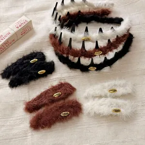 Plush headband set with metal labels in brown, black, and white colors for women