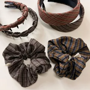 Detail view of striped fabric headbands and scrunchies featuring handmade woven labels