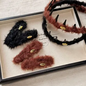 Brown and black plush headband and hair clip set with elegant gold metal logo labels