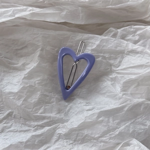 Close-up of purple heart-shaped resin hair clip with silver metal snap for Y2K style