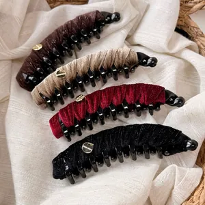 Velvet banana hair clips with gold handmade tags in burgundy, black, beige, and brown