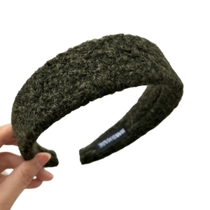 Deep green fleece headband with thick plush texture and handmade label for women