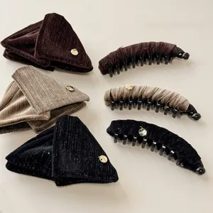 Close-up of velvet corduroy triangle hair clips and banana clips with golden charms