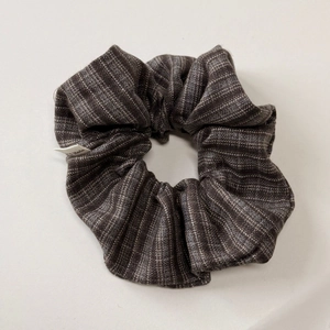 Detailed close-up of handmade striped fabric headband with Hand Made woven label