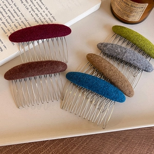 Vintage wool felt hair comb clips in various colors displayed on a ceramic tray