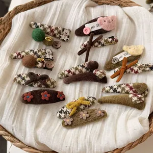 Detailed close-up of handmade retro autumn hair clips with plush bears and embroidery