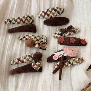 Retro brown hair clip set with plush bear and plaid bow patterns for autumn winter hair styling