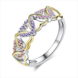 Detail of colorful gemstone heart ring with pavé purple and pink stones in gold bezels