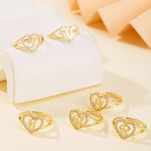 Adjustable gold heart rings with inlaid zircon and letters on elegant stone stands