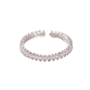 Detail view of silver open ring featuring a row of square cubic zirconia stones