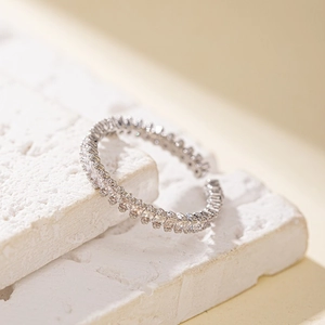 Macro detail of silver adjustable ring featuring hollow heart and cubic zirconia accents