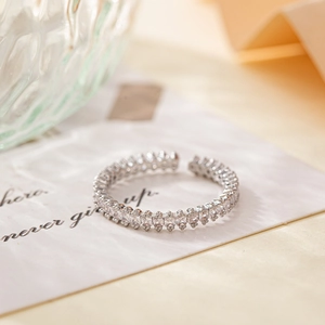 Minimalist open ring featuring square zirconia stones in a high-shine silver finish